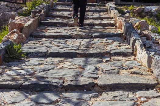 a man climbs the steps in the park back view, there is a place for an inscription. High quality photo