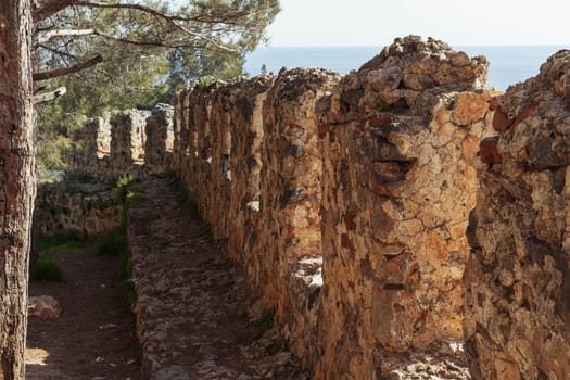 side view of the fence of the ancient fortress separates the sea there is a place for inscriptions. High quality photo