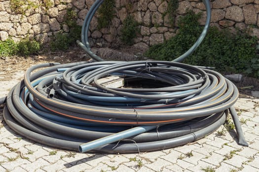 twisted water hose lies on the ground close-up,isolated on the ground. High quality photo