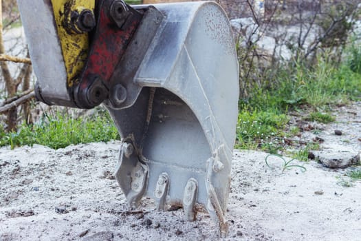 The excavator performs excavation work at the construction site. Crawler excavator digs. Earthmoving machinery, Excavator work close-up. High quality photo