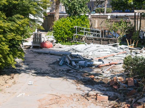 a dump in the middle of houses, a lot of construction debris lying around in the middle of residential buildings. High quality photo