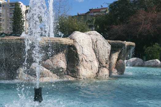 a large and beautiful fountain in the city center with transparent water. High quality photo