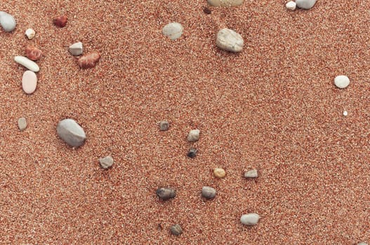 beach with yellow sand close-up, beautiful stones in the frame, background with a place for an inscription. High quality photo