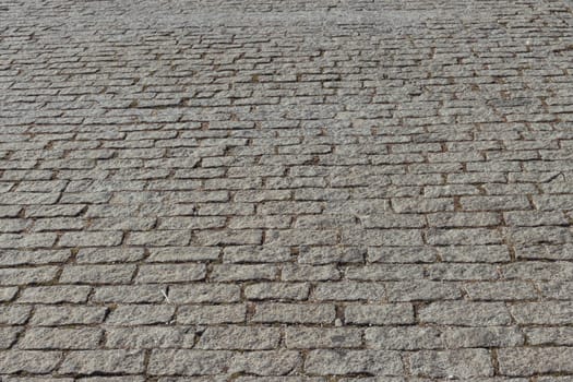 the road from the pavement is old in the city. There are green trees around, there is a place for an inscription. close-up High quality photo