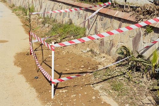 repair of a section of the road, fenced with a red tape so that no one walks. High quality photo