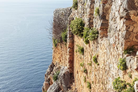 side view of the fence of the ancient fortress separates the sea there is a place for inscriptions. High quality photo