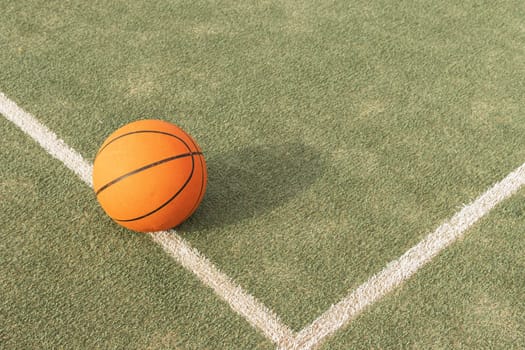 basketball ball isolated on the playing field on the right side there is a place for the inscription. High quality photo