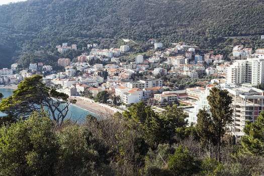 view of the city from the sea, not a big city at the bottom of the mountain overlooking the green forest.Beautiful landscape. High quality photo