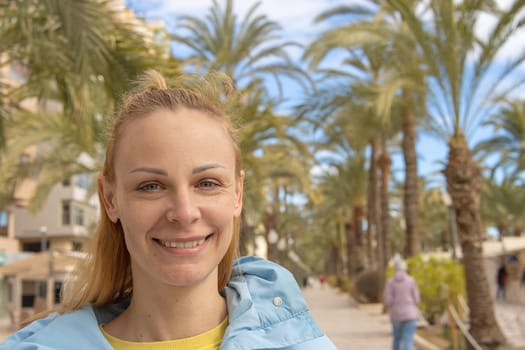 portrait of a girl on the embankment in spring in a jacket girl stands face close-up ,Beautiful seascape. High quality photo