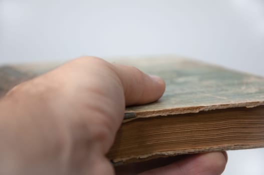 man hold out old book hand and book closeup. High quality photo