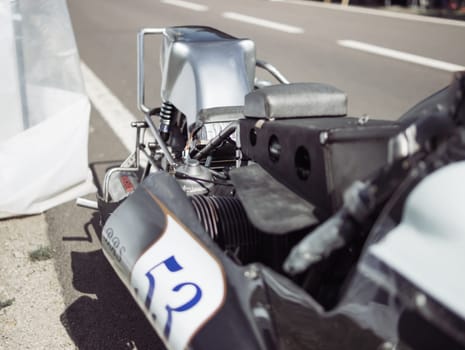 close-up of a motor on a rare racing car,black gray car with racing number High quality photo