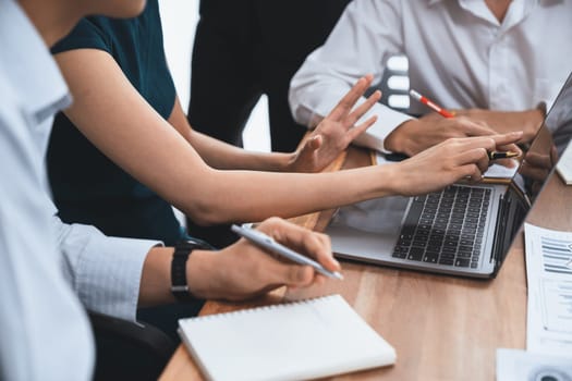 Multiracial analyst team use BI dashboard data to analyze financial report on meeting table. Group of diverse business people utilize data analysis by FIntech for success business marketing. Concord