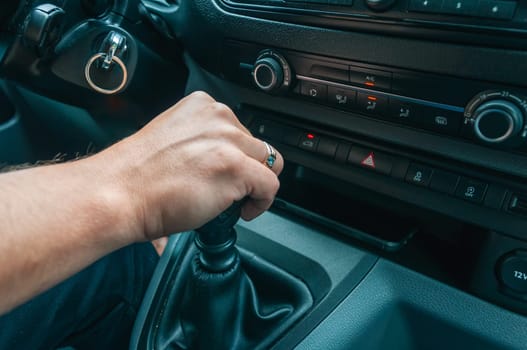 close-up of a man's hand, a man holds his hand on the gearshift lever in the car there is a place for an inscription. High quality photo