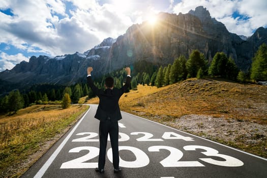 2024 New Year journey and future vision concept . Businessman traveling on highway road leading forward to happy new year celebration in beginning of 2024 for bliss and successful start .