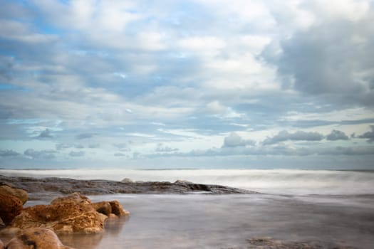 landscape photo of an evening beach overlooking the sea, an island can be seen in the distance, a photo of a sunset on the sea. High quality photo