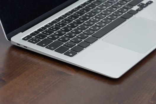 laptop on brown table close-up keyboard freelancer workplace remote work concept