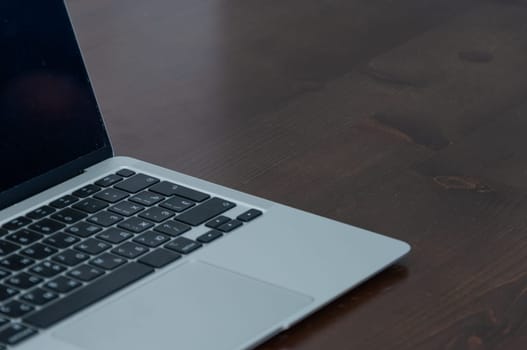 laptop on brown table close-up keyboard freelancer workplace remote work concept