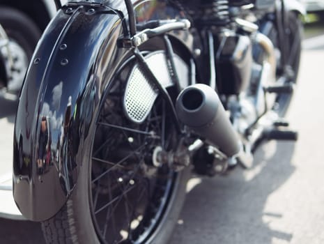 motorcycle rear wheel close-up, isolated motorcycle wheel on the street at the exhibition background blurred. High quality photo