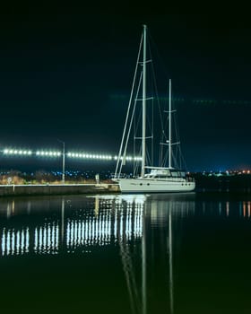 a white yacht in the sea is tied, a photo of the night sea, there is a place for an inscription. A beautiful sea evening landscape. High quality photo