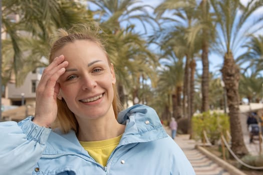 portrait of a girl on the embankment around the palm tree. High quality photo