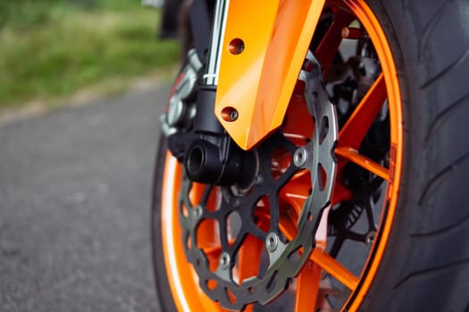 isolated wheel from a motorcycle close-up of an orange wheel, there is a place for an inscription. High quality photo