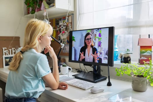 Online session of teenage girl and psychologist, social worker. Young female talking to therapist, teacher, at home looking at computer screen. Professional help, mental health, education, adolescence