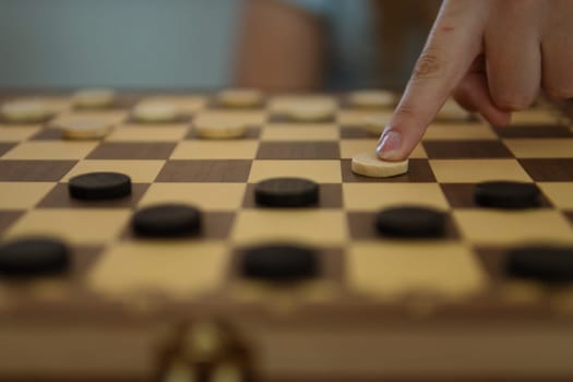 close-up view of a hand of elderly woman playing chess. High quality photo