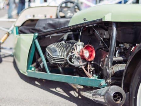 close-up of a motor on a rare racing car, a close-up of a green car. High quality photo