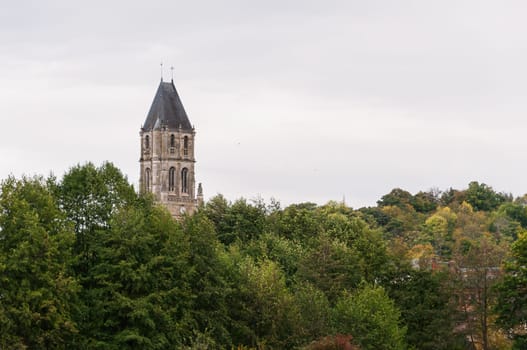 top view, among the green trees you can see the roof of an old building, close-up there is a place for an inscription, the architecture is old. High quality photo