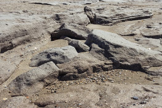 big stones on the beach and sand close up there is a place for inscriptions. High quality photo