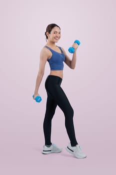 Vigorous energetic woman doing dumbbell weight lifting exercise on isolated background. Young athletic asian woman strength and endurance training session as body workout routine.