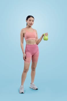 Vigorous energetic woman doing kettlebell weight lifting exercise on isolated background. Young athletic asian woman strength and endurance training session as body workout routine.