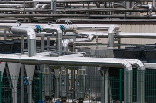 Equipment, cables and pipelines outside a modern cheese factory in France, close-up. High quality photo