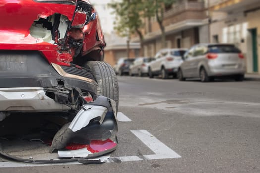 red car after an accident, the insurance for the car damaged in the accident.The front bumper of the car all damaged after the accident. High quality photo