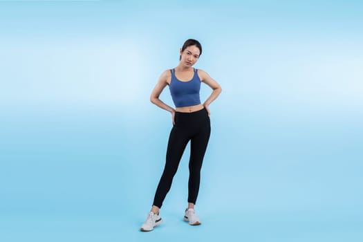 Full body asian woman in sportswear portrait, smiling and posing cheerful gesture. Workout training with attractive girl engage in her pursuit of healthy lifestyle. Isolated background Vigorous