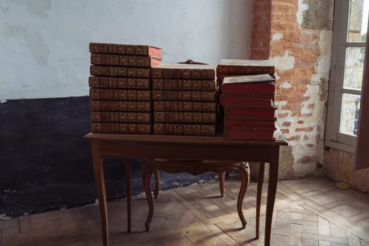 old chateau castle, a room where there is an antique table and books on it close-up. High quality photo