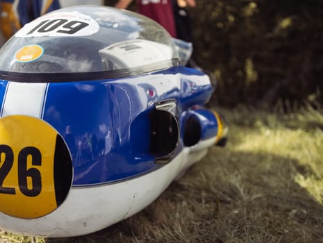 racing on old rare cars, a place for an assistant driver. A blue flask with a participant number close-up. High quality photo