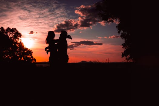 Couple dancing salsa at sunset,silhouette of couple in love at sunset against the backdrop of nature. High quality photo