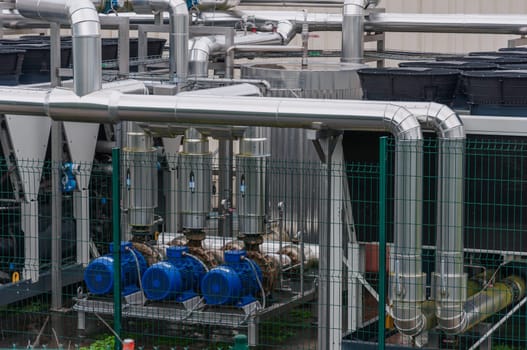 Equipment, cables and pipelines outside a modern cheese factory in France, close-up. High quality photo