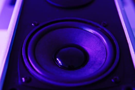 sound speaker in purple neon light.Powerful music concept. High quality photo