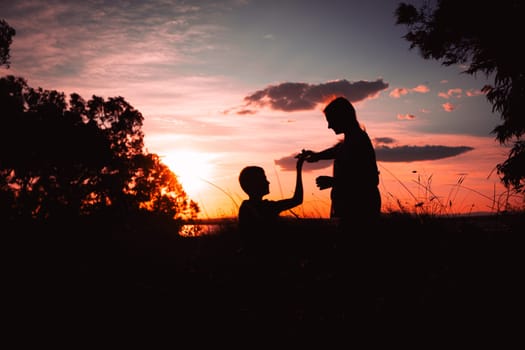 Beautiful silhouettes of two dancers at sunset. silhouette of brother and sister dancing at sunset. High quality photo
