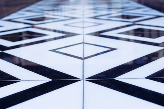 Builders laying tiles, new black and white tiles on the floor. Renovation concept. High quality photo