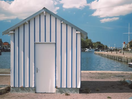 the house is small for security on the pier, near the sea.there is a place for an inscription in the port town. High quality photo