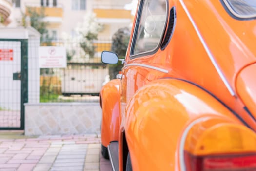 retro car orange color close-up on the street. High quality photo