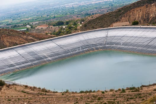 artificial lake close-up in the middle of the mountains, there is a place for an inscription. High quality photo