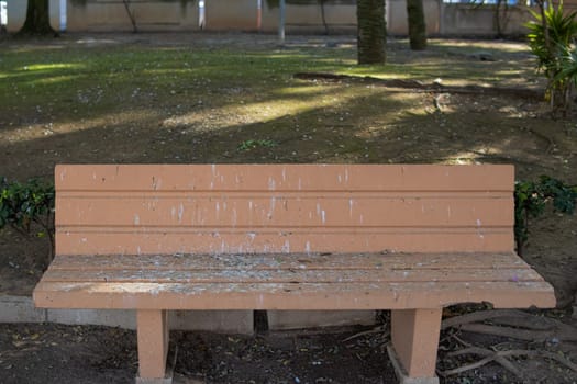 park bench close-up, all dirty, bird droppings bench in the park. High quality photo