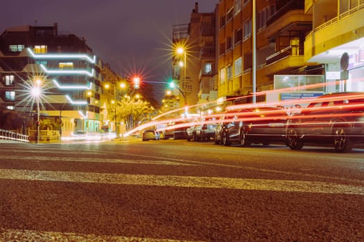 night European city, lights from passing cars on the road. Landscape of a night city, there is a place for an inscription. High quality photo