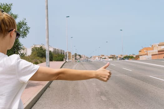 A young woman catches a car on the road close-up on her hand, automatic stop, automatic braking, travel, travel. High quality photo