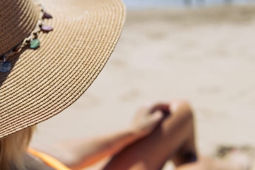 a girl in a hat, a close-up on the tanned and slender legs of a girl, there is a place for an inscription. High quality photo