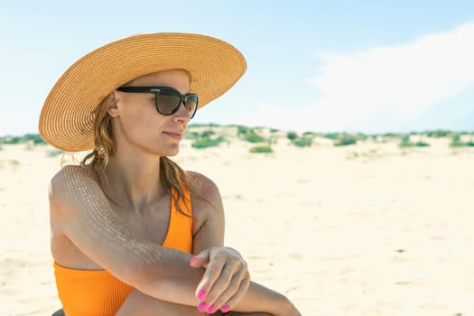 portrait of a girl in a swimsuit, glasses and a hat on the beach, Photo of a seascape with a girl. High quality photo